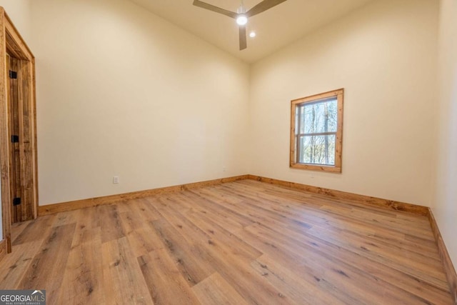 unfurnished room with light wood finished floors, a ceiling fan, and baseboards