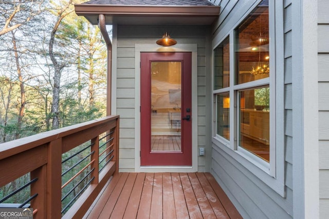 property entrance with a shingled roof