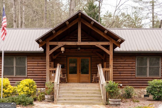 doorway to property featuring french doors and metal roof