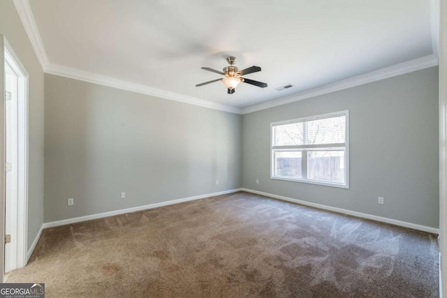 spare room with visible vents, ornamental molding, a ceiling fan, carpet floors, and baseboards