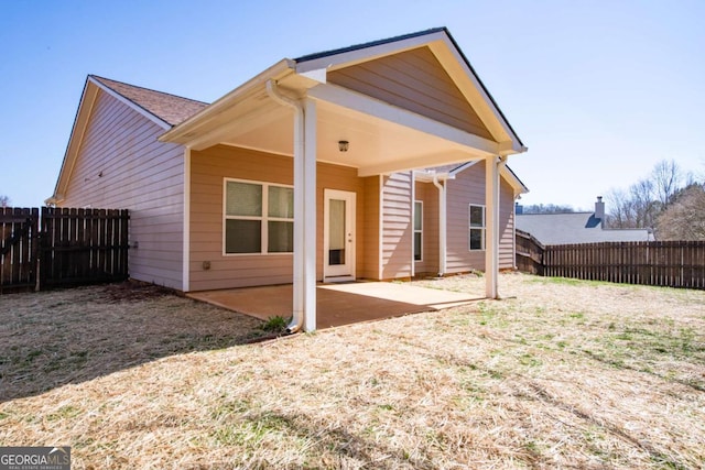 back of house featuring a patio area and a fenced backyard