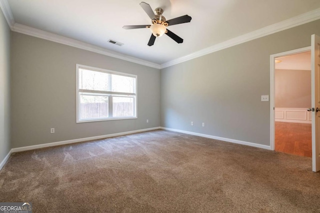 unfurnished room featuring ceiling fan, carpet, visible vents, and ornamental molding