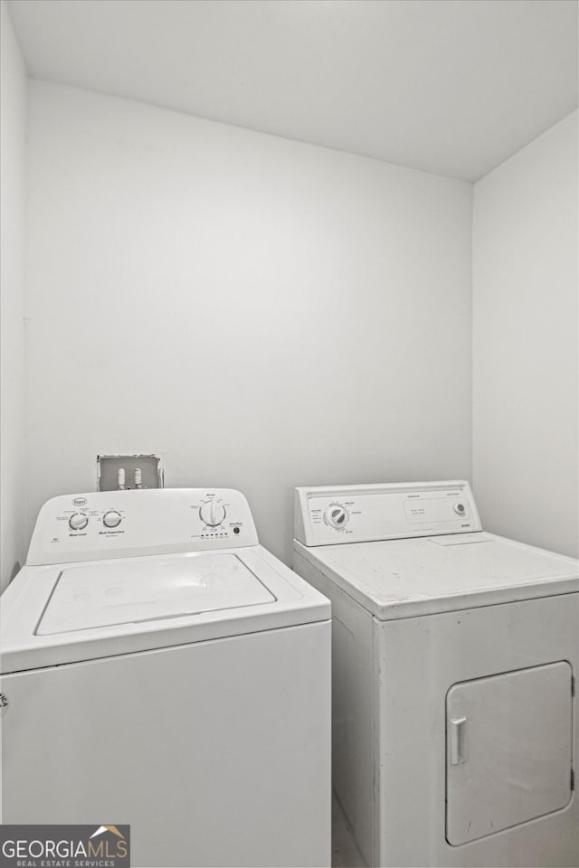 clothes washing area featuring washer and dryer and laundry area