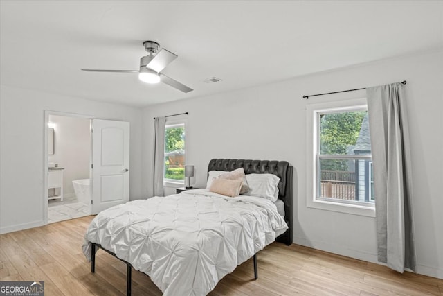 bedroom featuring a ceiling fan, baseboards, visible vents, and light wood-type flooring