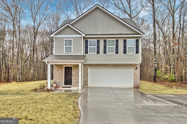 view of front of house with brick siding, a garage, concrete driveway, and a front yard