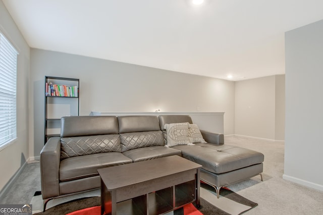 carpeted living room featuring baseboards