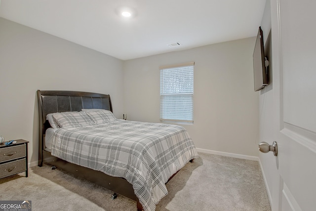 bedroom featuring visible vents, baseboards, and carpet