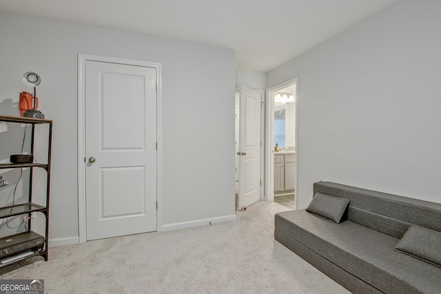 sitting room featuring baseboards and carpet floors