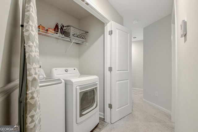 laundry room featuring baseboards, light carpet, laundry area, and washing machine and clothes dryer