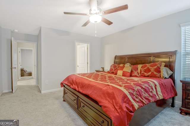 bedroom with ceiling fan, baseboards, and light carpet