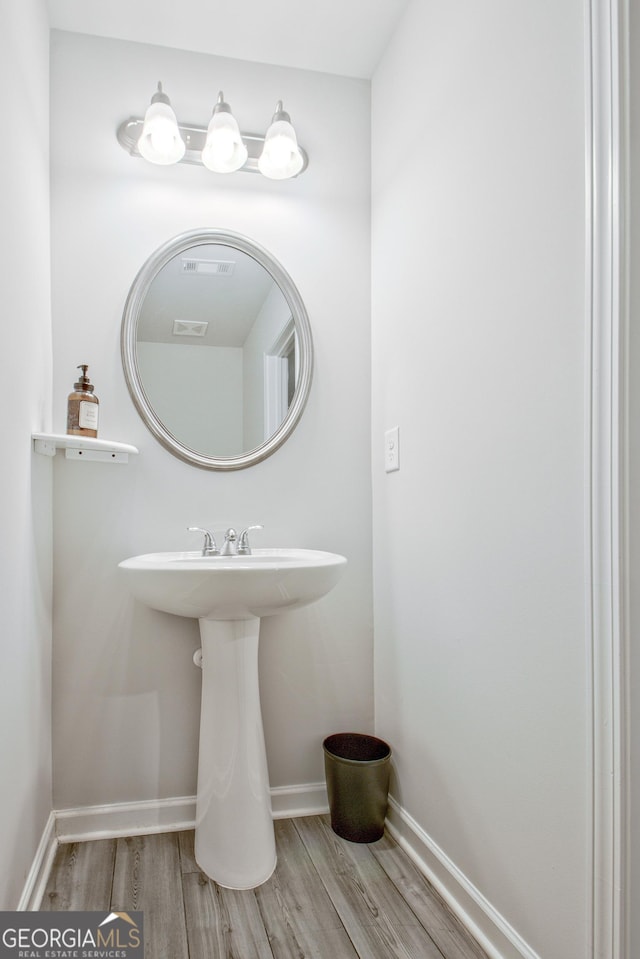 bathroom featuring baseboards and wood finished floors