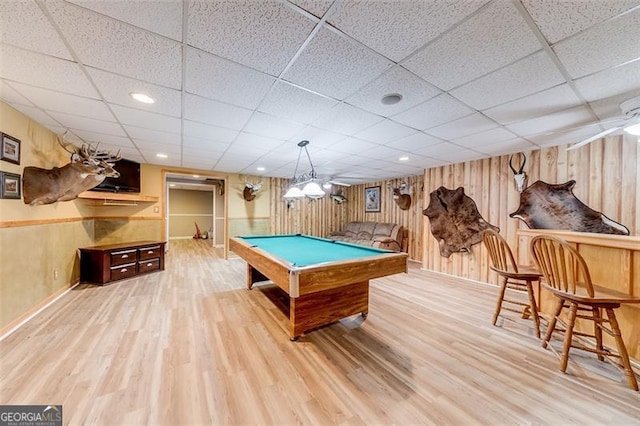 recreation room featuring pool table, wooden walls, wood finished floors, and a paneled ceiling