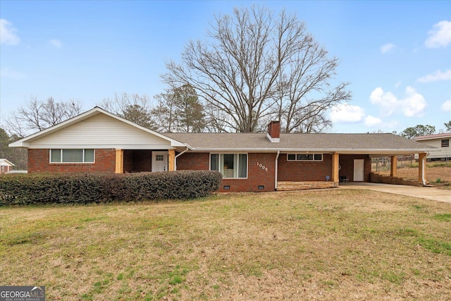 ranch-style home featuring brick siding, an attached carport, a front yard, a chimney, and driveway