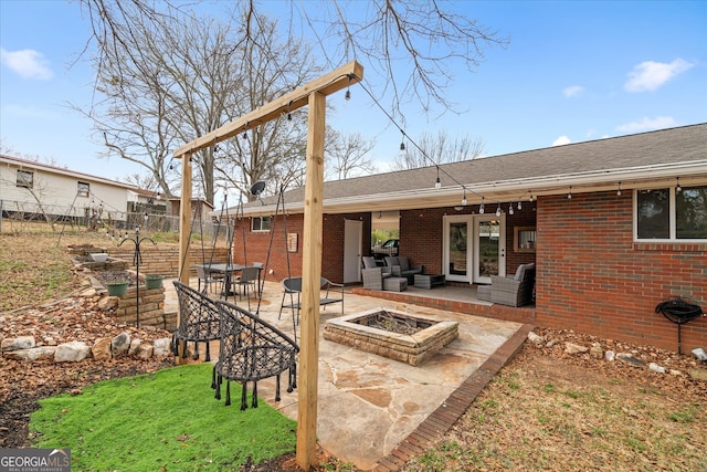 view of patio featuring an outdoor living space with a fire pit and fence