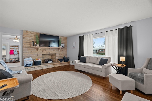 living area with a ceiling fan and wood finished floors