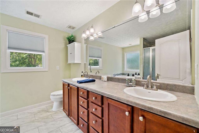 full bathroom featuring visible vents, a wealth of natural light, and a sink