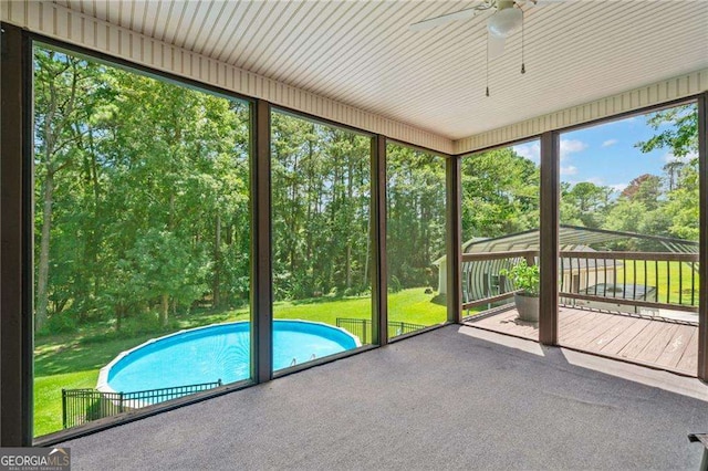 unfurnished sunroom featuring ceiling fan