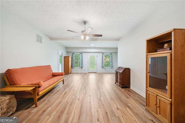 sitting room with visible vents, a ceiling fan, a textured ceiling, light wood finished floors, and baseboards