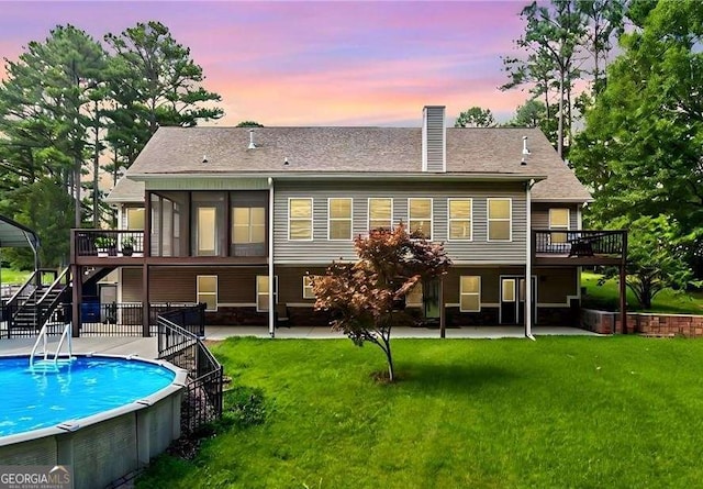 rear view of property featuring a deck, stairway, and a patio area