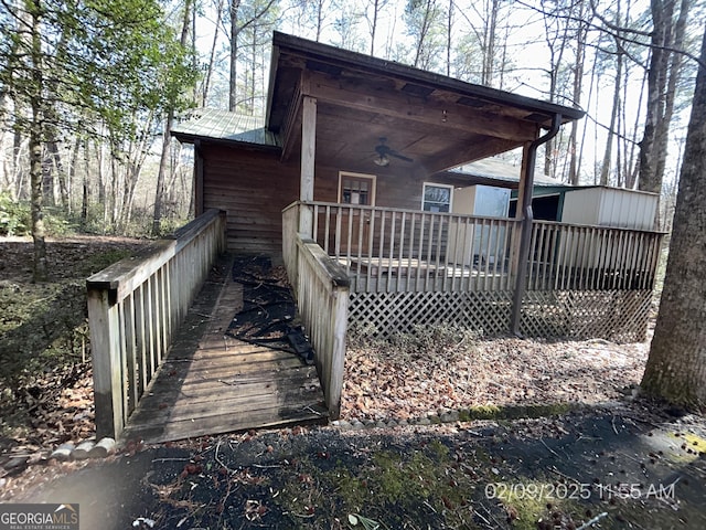 rear view of house with metal roof and ceiling fan