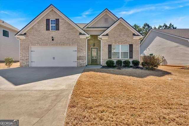 view of front of house with a front lawn, a garage, brick siding, and driveway