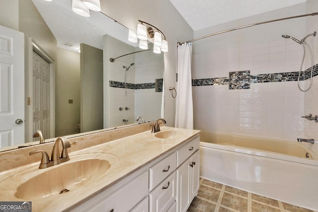 bathroom with double vanity, shower / tub combo with curtain, and a sink