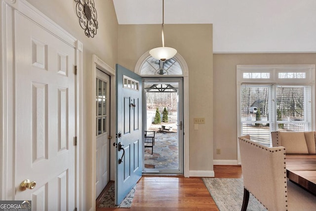 entryway featuring baseboards and wood finished floors