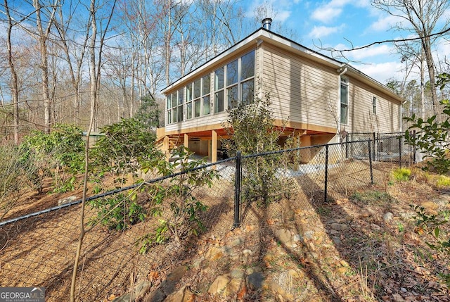 view of property exterior featuring fence