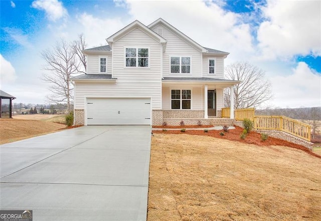 craftsman-style home with a garage, covered porch, brick siding, and driveway