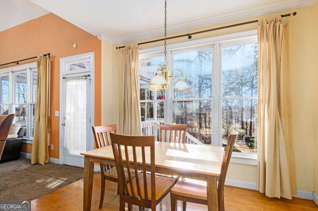 dining room featuring a healthy amount of sunlight, baseboards, and a chandelier