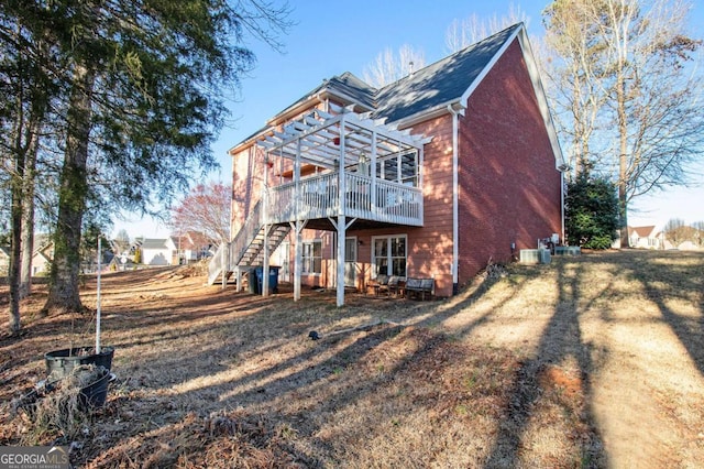 back of house featuring stairway, a wooden deck, a pergola, central air condition unit, and brick siding