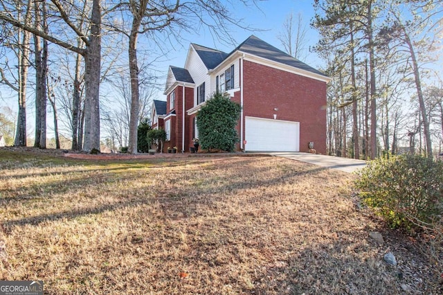 view of property exterior with brick siding, a yard, driveway, and a garage