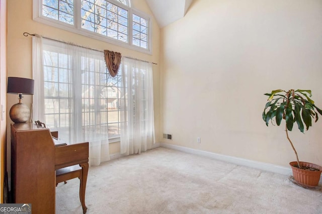 living area featuring visible vents, baseboards, carpet floors, and high vaulted ceiling