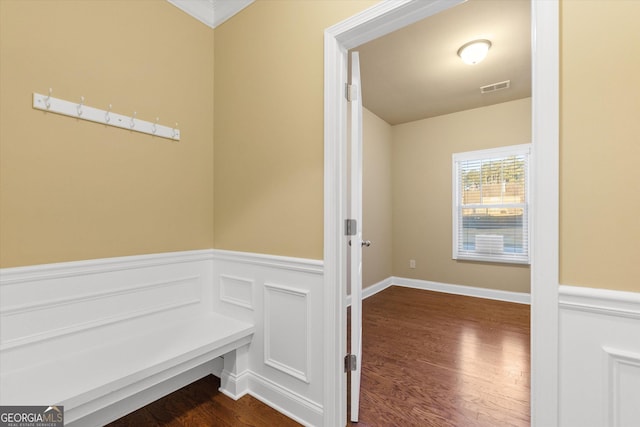 mudroom with visible vents, dark wood-style flooring, and wainscoting