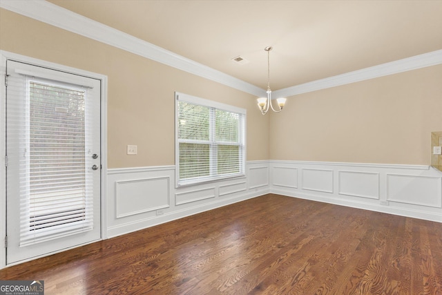 unfurnished dining area featuring visible vents, dark wood finished floors, ornamental molding, wainscoting, and a notable chandelier