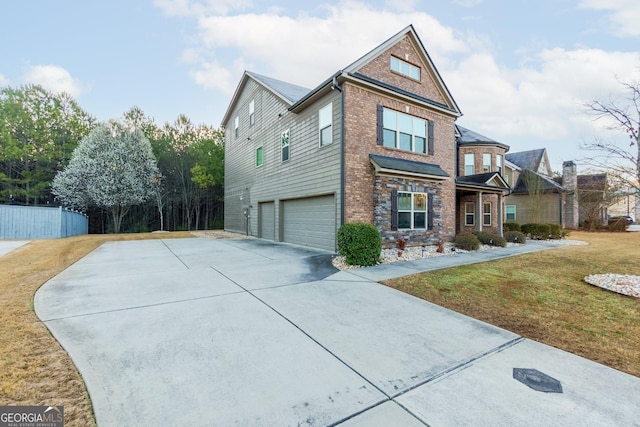 view of front of property with fence, driveway, a front lawn, a garage, and brick siding