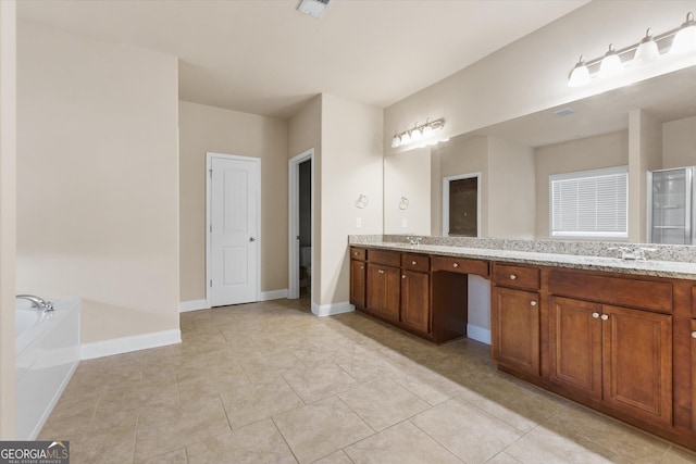 full bath featuring baseboards, double vanity, a stall shower, a bath, and a sink