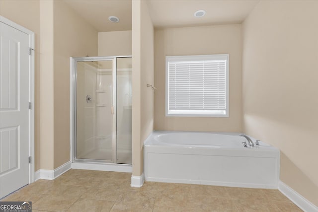 full bathroom featuring baseboards, a garden tub, a shower stall, and tile patterned flooring