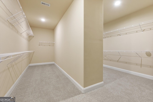 walk in closet featuring carpet flooring and visible vents