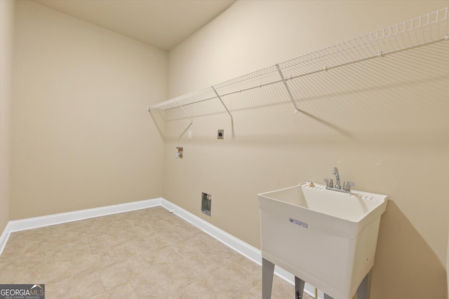 washroom with baseboards, laundry area, hookup for a washing machine, hookup for an electric dryer, and a sink