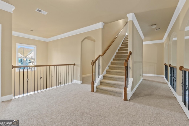 staircase with visible vents, baseboards, carpet flooring, and crown molding