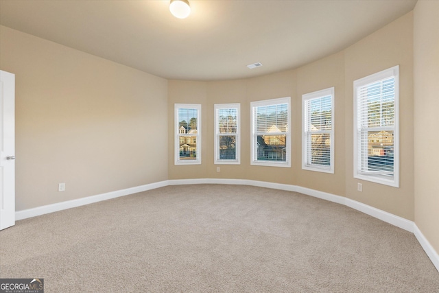 unfurnished room featuring baseboards and carpet