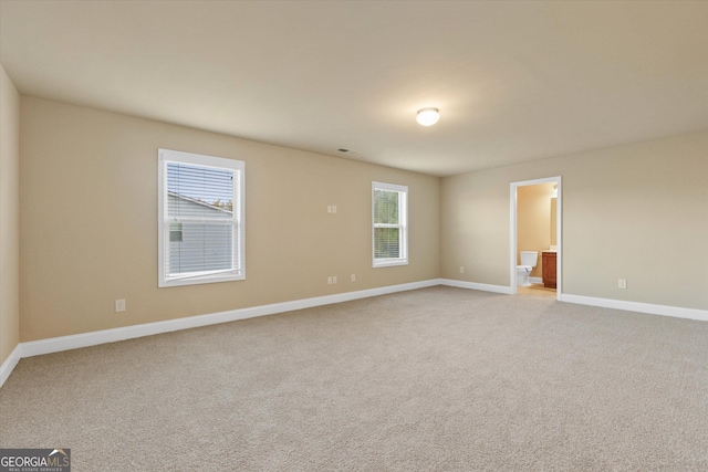 empty room with light colored carpet and baseboards