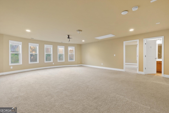 empty room with recessed lighting, baseboards, and light carpet