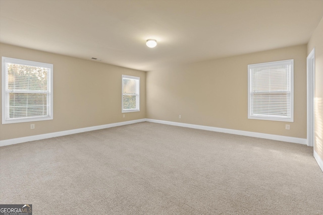 carpeted spare room with baseboards