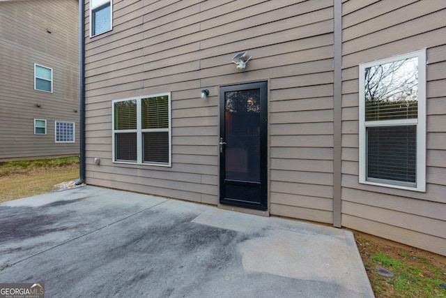 entrance to property featuring a patio