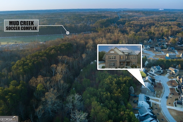 birds eye view of property featuring a view of trees