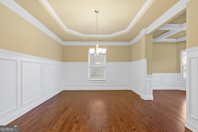 unfurnished dining area with dark wood finished floors, an inviting chandelier, and a decorative wall