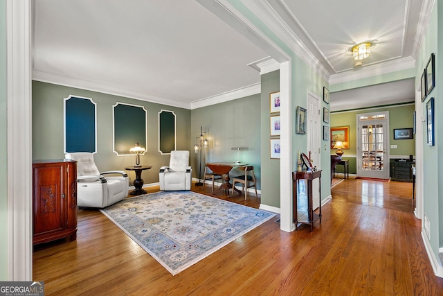 interior space with wood finished floors, baseboards, and ornamental molding