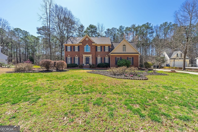 view of front of home with brick siding and a front yard